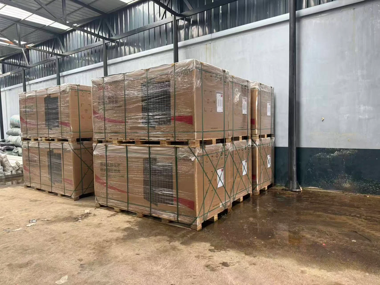 Packaged solar modules stored on pallets inside the BaiTeESS warehouse